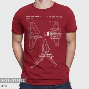 May include: A red t-shirt with a white print of a Star Wars X-wing fighter patent design. The patent number is Des. 277,116 and the date is Jan. 5, 1955. The text "United States Patent" is also included in the print.