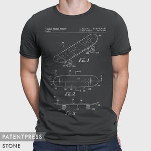 May include: A dark gray t-shirt with a white print of a skateboard patent design. The patent number is US 6,648,363 B2 and the date of the patent is Nov. 18, 2003. The text "United States Patent" and "Gordon" are also printed on the shirt.