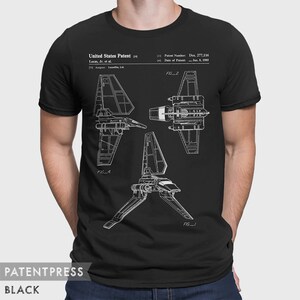 May include: Black t-shirt with a white print of a Star Wars X-wing fighter patent drawing. The patent number is Des. 277,116 and the date is Jan. 8, 1985. The text "United States Patent" and "Lucas, Jr. et al." are also included in the print.