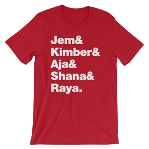 May include: Red t-shirt with white text that reads "Jem & Kimber & Aja & Shana & Raya."