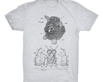 Furby T-Shirt. Cute Toy Patent Print Tee. Comfy Gift. Ringspun Cotton Shirt . Unisex. Sizes S-3X. Available in Black, Red, White, or Gray.