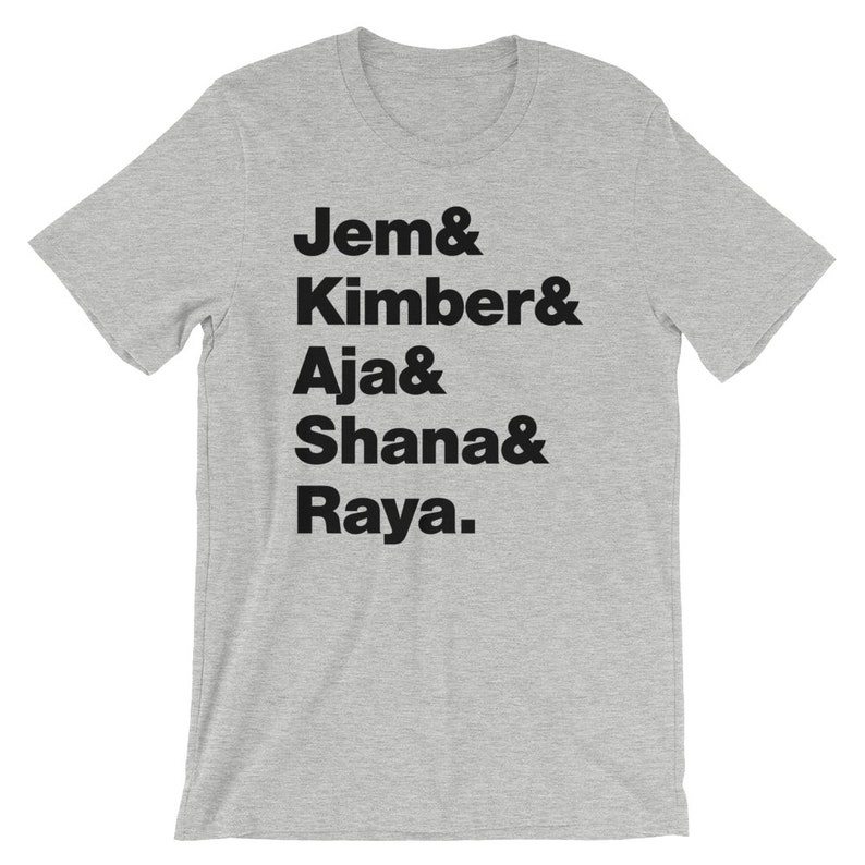 May include: Grey t-shirt with black text that reads "Jem & Kimber & Aja & Shana & Raya."