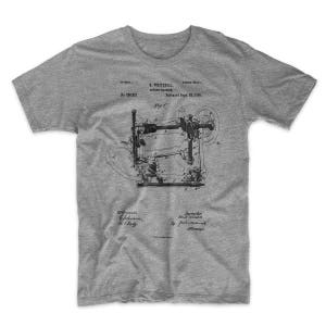 Sewing Machine Patent T-Shirt. Seamstress Tailor T-Shirt. Ringspun Cotton Tee. Unisex. Sizes S-4X. Available in Black, Red, White, or Gray.