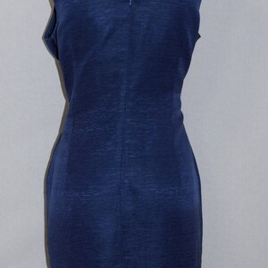 May include: A sleeveless navy blue dress with a scoop neckline and a back zipper closure.
