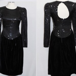 May include: A black sequined and velvet dress with long sleeves and a keyhole back. The dress has a fitted bodice and a flowing skirt.