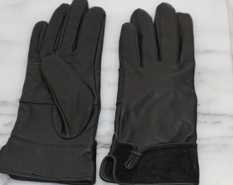May include: A pair of black leather gloves with a suede cuff. The gloves have a simple design and are suitable for cold weather.