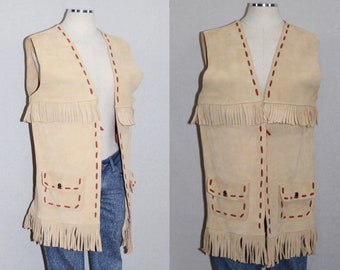 May include: A tan suede vest with fringe detailing and red stitching. The vest has two pockets with button closures.