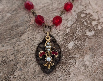 Small vintage red fleur de lis pendant with red glass rosary chain