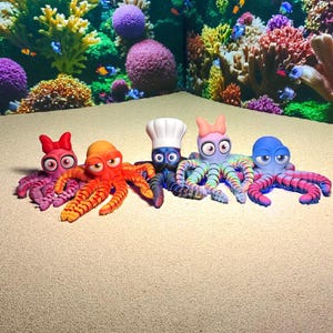 May include: Five colorful octopus figurines with expressive faces and various accessories, including a chef's hat and bows. The octopuses are arranged on a sandy surface, with a vibrant coral reef backdrop.