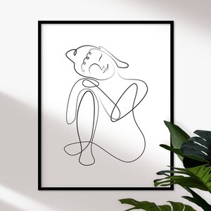 May include: A black and white line drawing of a person sitting with their head resting on their hand. The drawing is in a simple, minimalist style.