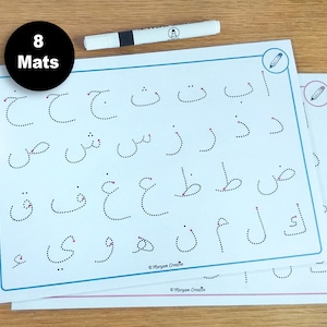 May include: Eight tracing mats for learning the Arabic alphabet. Each mat features dotted lines for tracing the letters. The mats are white with blue and pink borders.
