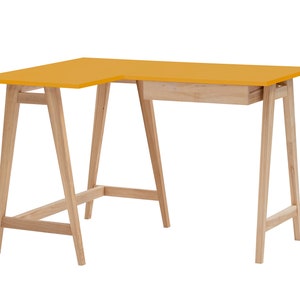 May include: An L-shaped desk featuring a bright yellow tabletop surface and a light-toned wooden frame. The desk is supported by four angled legs connected by horizontal crossbars and includes a single drawer mounted under the tabletop.