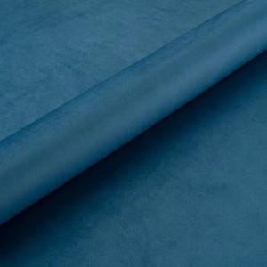 May include: A close-up of a solid teal blue fabric. The fabric has a soft, velvety texture.