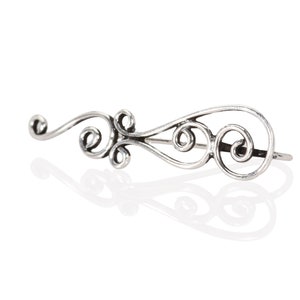 May include: Silver ear cuff with a delicate, swirling design. The cuff is made of a single piece of metal and has a simple, elegant look.