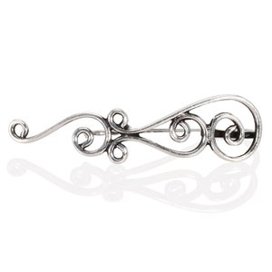 May include: A silver brooch with a delicate, swirling design. The brooch is made of metal and has a polished finish.