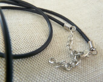 May include: A black cord necklace with a silver chain and clasp. The cord is doubled and the clasp is a spring ring.