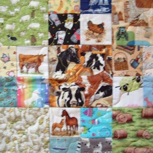 May include: A colorful patchwork quilt with various images, including farm animals, musical notes, and hay bales. The quilt is made up of many different squares, each with a unique design.