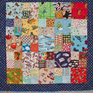 May include: A colorful patchwork quilt with a blue border and a variety of patterns, including airplanes, animals, and cars.