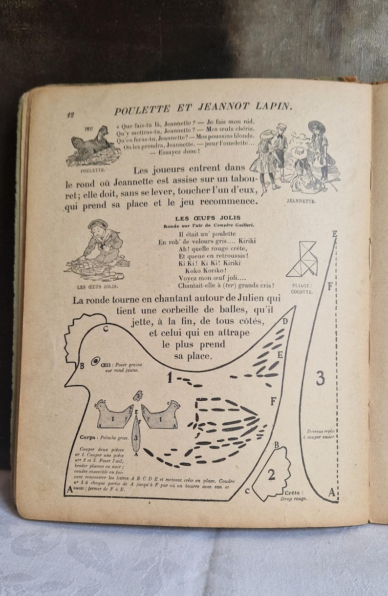 May include: An open book page with French text and illustrations. The page features a drawing of a chicken and instructions for a game. The text includes phrases like "Poulette et Jeannot Lapin" and "Les oeufs jolis."