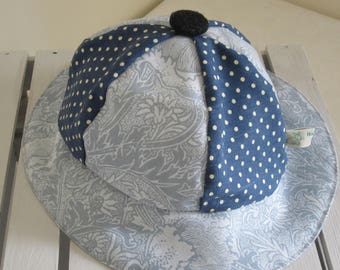 Child's Sun Hat Made of Grey and White Floral Cotton Fabric and Navy Polka Dot Insert and Pure White Lining with a Button Top Detail