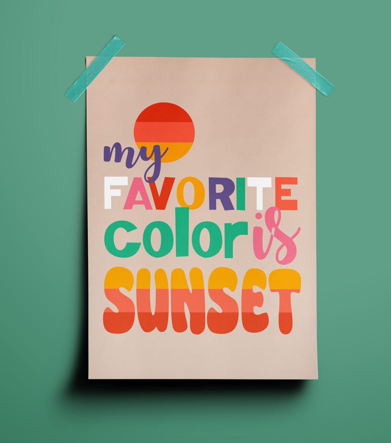 May include: A beige poster with the text "my FAVORITE color is SUNSET" in colorful, retro-style lettering. A circular graphic of a sunset is at the top. The poster is taped to a green background with blue tape.
