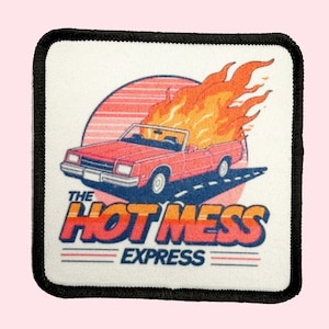 May include: A white square patch with black stitching around the edges. The patch features a red convertible car with flames coming out of the back. The car is driving on a road with a sunset in the background. The text "The Hot Mess Express" is printed in blue and white letters below the car.