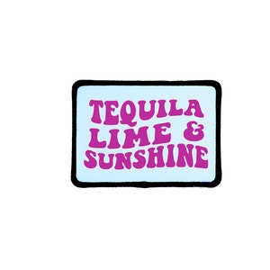 May include: A rectangular patch with a light blue background and a black border. The patch features the words "TEQUILA LIME & SUNSHINE" in a retro, purple font.