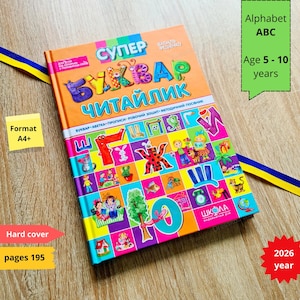 Puede incluir: Un colorido libro de alfabeto para niños con el título "SUPER" en letras grandes. El libro tiene tapa dura, 195 páginas y está diseñado para niños de 5 a 10 años. La portada muestra el texto "Alphabet ABC" y el año 2026.