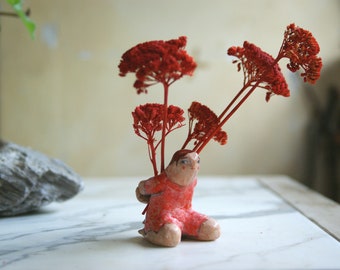 Flowers for you, terracotta sculpture, boy carrying large red flowers, table artistic object, art, statuette, kneeling figurine