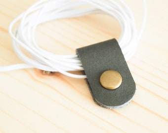 Cord Clip in Dark Grey > Solid Brass Snap > Full Grain Leather > Cord Keeper > Cord Organiser > Antique Brass Snap > Ear Bud Organiser