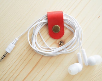 Cord Clip in Red/Orange > Solid Brass Snap > Full Grain Leather > Cord Keeper > Cord Organiser > Antique Brass Snap > Ear Bud Organiser