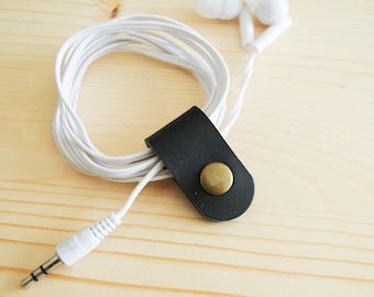 Cord Clip in Black > Solid Brass Snap > Full Grain Leather > Cord Keeper > Cord Organiser > Antique Brass Snap > Ear Bud Organiser