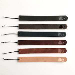 May include: Six leather bookmarks in different colours, each with the word "illo" embossed on the end.