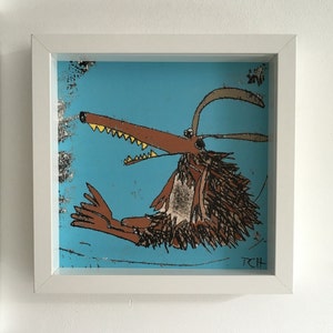 May include: A framed illustration of a brown, furry creature with a long snout and sharp teeth. The creature has a yellow horn and is set against a blue background. The artist's initials, "RCH", are in the bottom right corner.