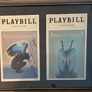 May include: Framed Playbills from the Walter Kerr Theatre, featuring the play "Angels in America." One Playbill has a signature. The artwork depicts figures with angel wings in shades of blue and gray.