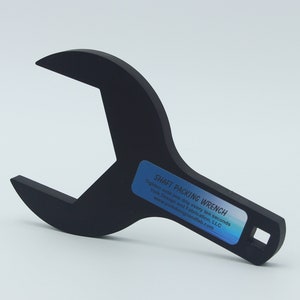 May include: Black metal wrench with a square opening on the handle. The wrench is labeled "SHAFT PACKING WRENCH" and includes instructions to tighten until one drip every ten seconds. The label also includes the company name "York Design and Fabrication, LLC" and website address "www.yorkdesignandfab.com".