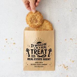May include: A brown paper bag with a printed design that says "It would be a real treat to be your real estate agent". The bag is filled with two cinnamon sugar cookies.