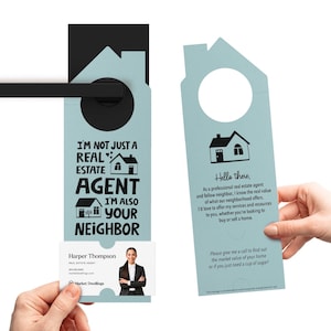 two hands holding a door hanger with a picture of a house