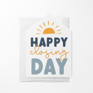 May include: A white card with a house shape, a yellow sun with rays, and the text "HAPPY closing DAY" in blue and black lettering.