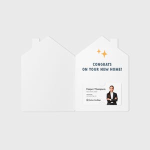May include: A white house-shaped card with a gold star design and the text "Congrats on your new home!"  Inside the card is a business card with a woman's photo and the text "Harper Thompson, Real Estate Agent, Market Dwellings".