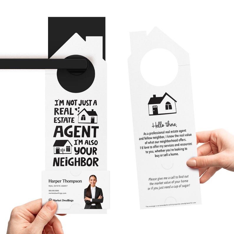 a person holding a door hanger with a picture of a house on it