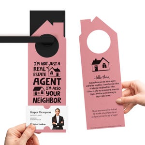 a pink door hanger with a picture of a house
