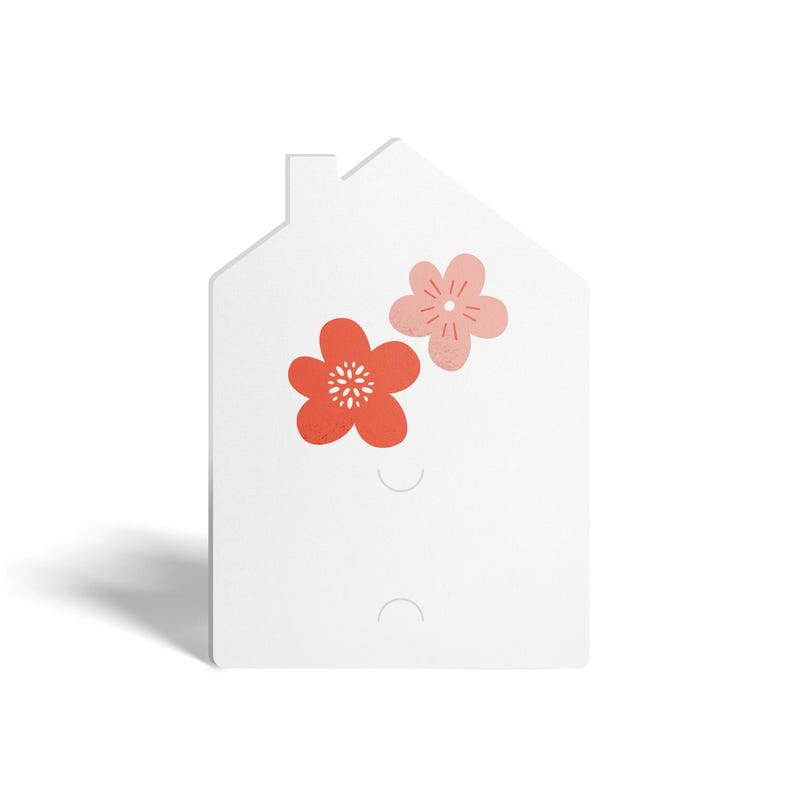 May include: White house-shaped card with two pink and red flowers. The card has two holes for hanging.