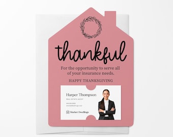 May include: A pink house-shaped card with a wreath and the word "thankful" in black script. The card has a business card insert with a photo of a woman and the text "Harper Thompson, Real Estate Agent, 555.555.5555, marketdwellings.com, Market Dwellings".