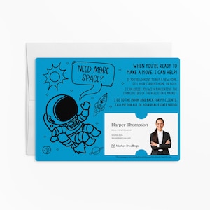 May include: A blue and white business card with a cartoon astronaut and the text "Need more space?"  The card also includes the text "When you're ready to make a move, I can help!" and the name "Harper Thompson" with contact information.