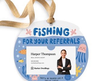 May include: A round, blue and white, illustrated, real estate referral tag with a picture of a woman in a business suit. The tag has the text "*FISHING FOR YOUR REFERRALS" and "THEY'LL BE TREATED LIKE A SPECIAL CATCH!" with a cartoon fish, crab, and jellyfish.