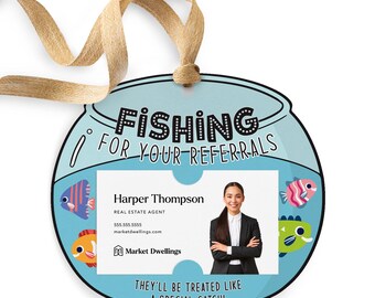 May include: A blue and white fishbowl-shaped tag with the text "Fishing for your referrals" and a business card inside. The business card has a photo of a woman with the text "Harper Thompson, Real Estate Agent, 555.555.5555, marketdwellings.com, Market Dwellings". The tag also has the text "They'll be treated like a special catch!"
