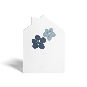 May include: White house-shaped wall decor with two blue floral designs. The house has two holes for hanging.