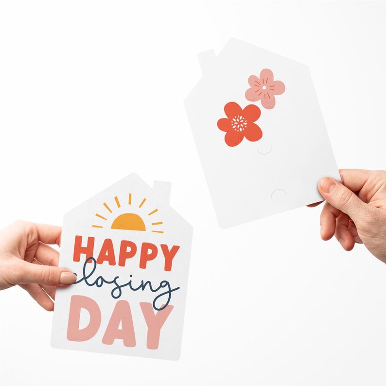 May include: Two white house-shaped cards with a sun and the text "HAPPY closing DAY" on one card and two pink flowers on the other card.