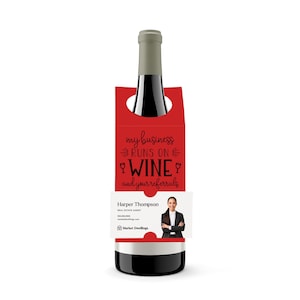 May include: Red wine bottle holder with a white label and a photo of a woman. The holder has the text "my business runs on wine and your referrals".